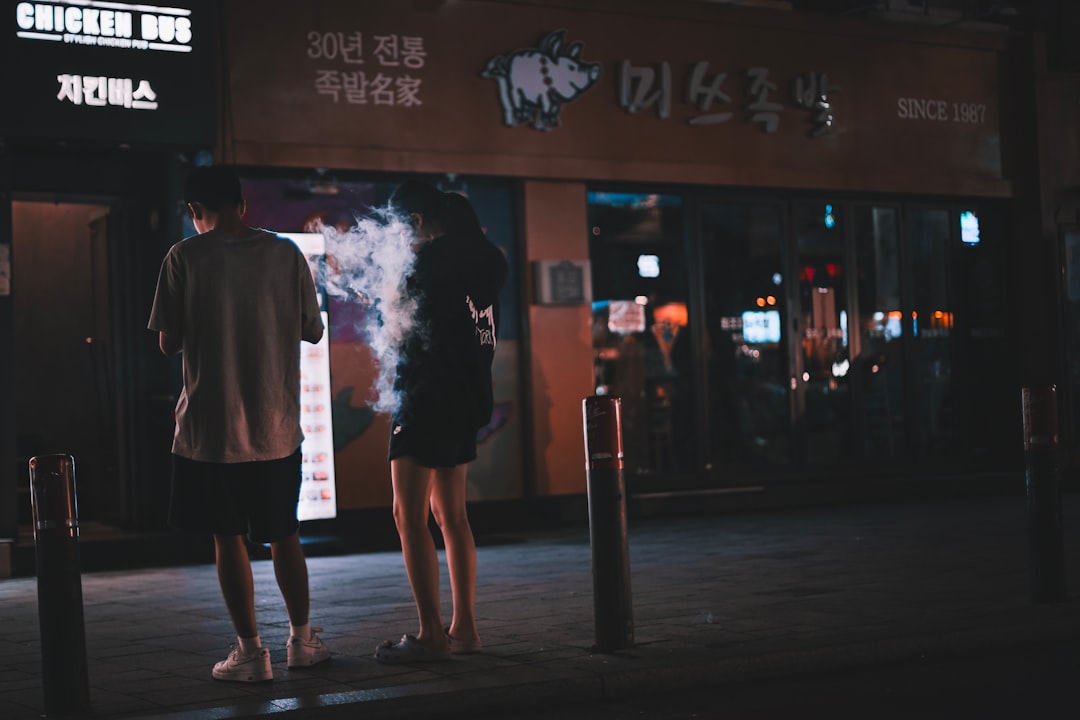 Vibrant Hongdae street at night with neon lights, cafes, and young people