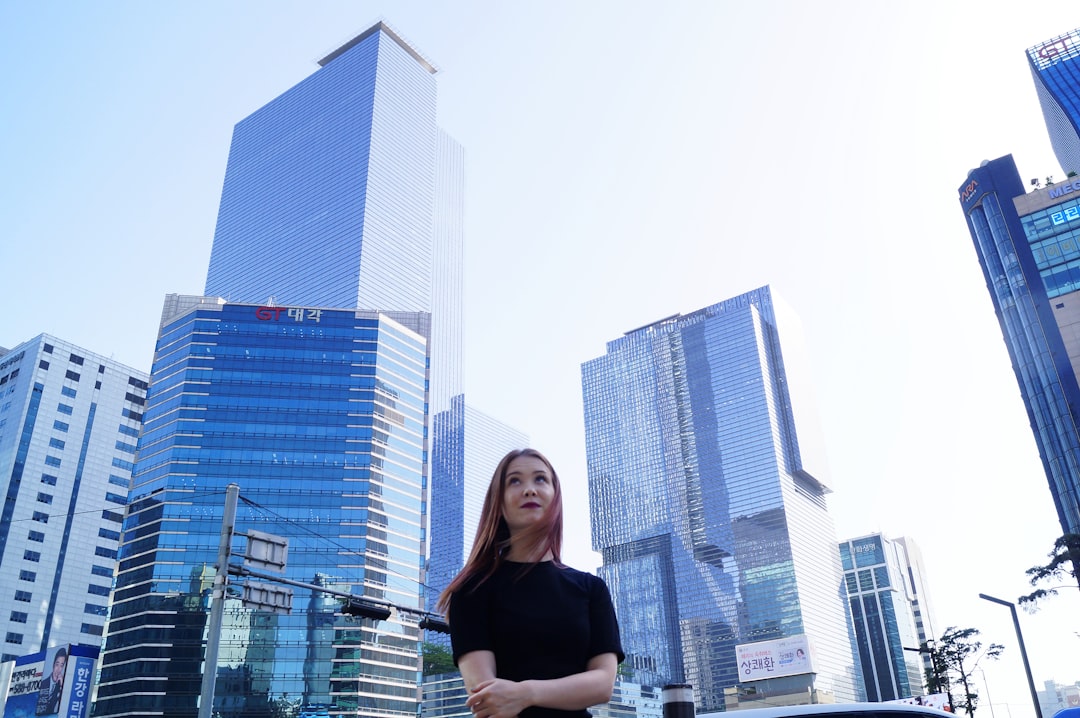 Korean language teacher smiling with Seoul cityscape background
